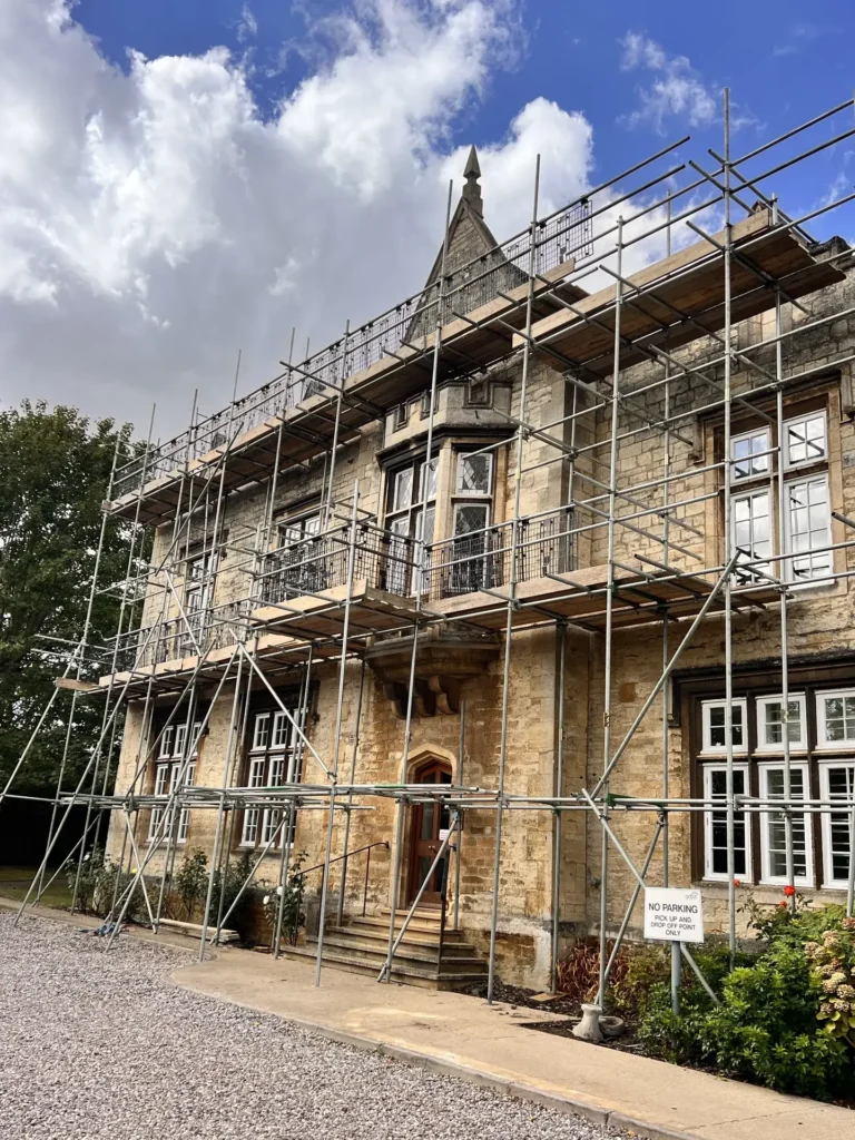 Scaffolding around a stone commercial building