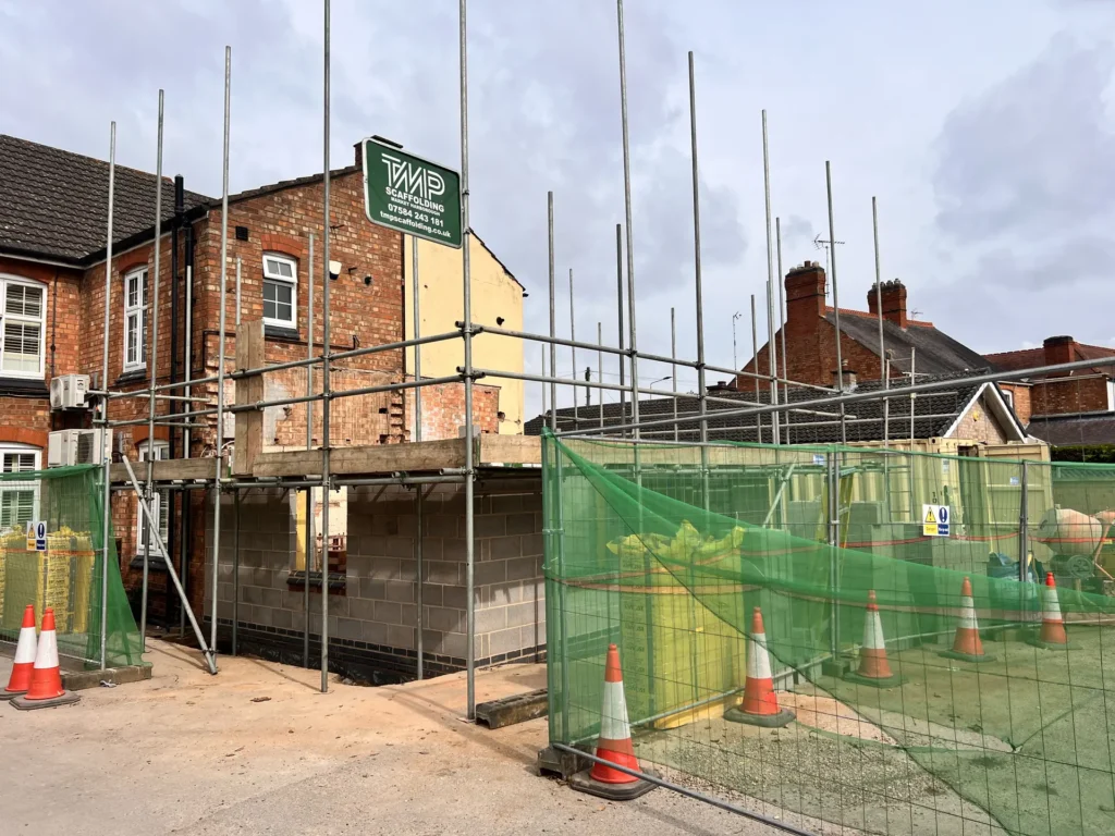 Scaffolding around a brick property during building work