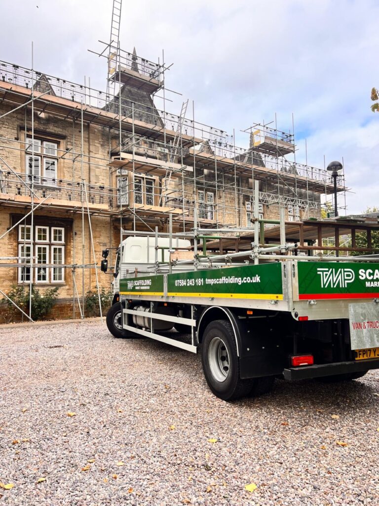 TMP Scaffolding truck at a scaffolded building