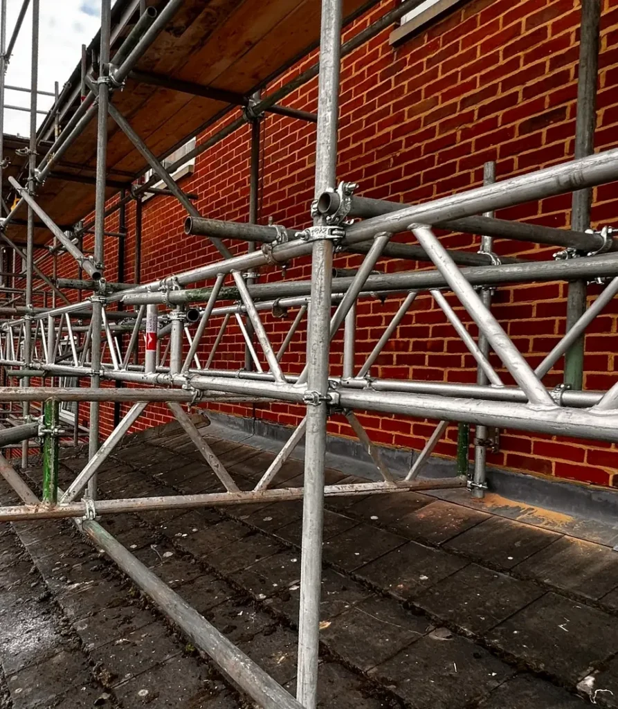 Scaffold platforms alongside a brick building