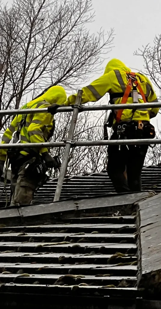 Two TMP team members handling scaffold components