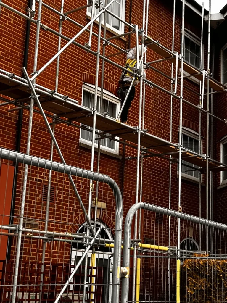 Scaffolding erected beside a brick building